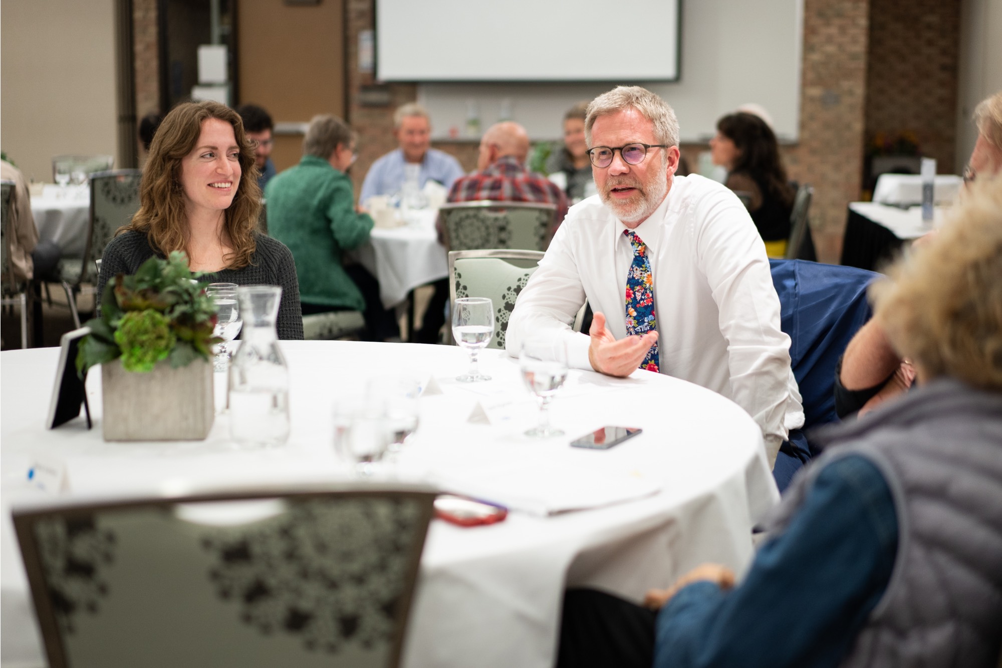 Dean Shuab talking with table